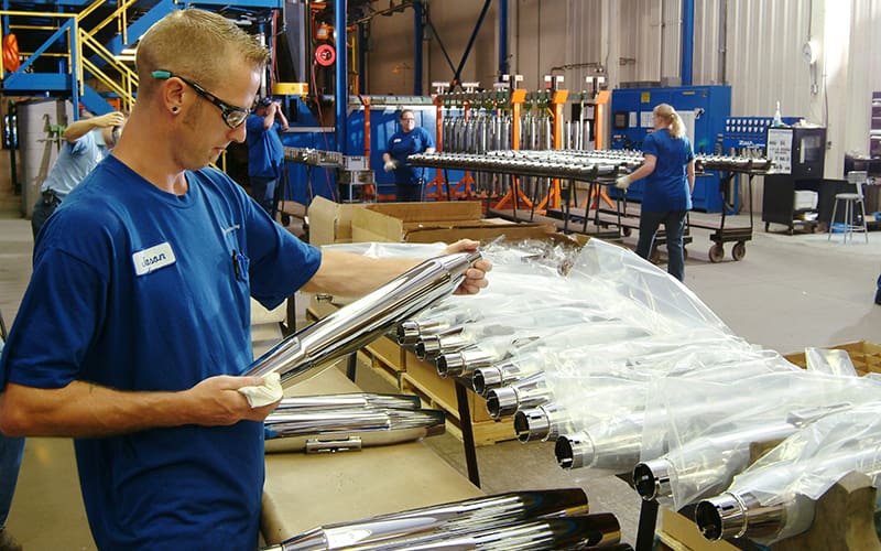 worker at assembly line with parts